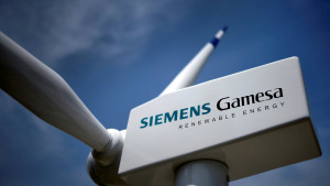 FILE PHOTO: A model of a wind turbine with the Siemens Gamesa logo is displayed outside the annual general shareholders meeting in Zamudio, Spain, June 20, 2017. REUTERS/Vincent West/File Photo
